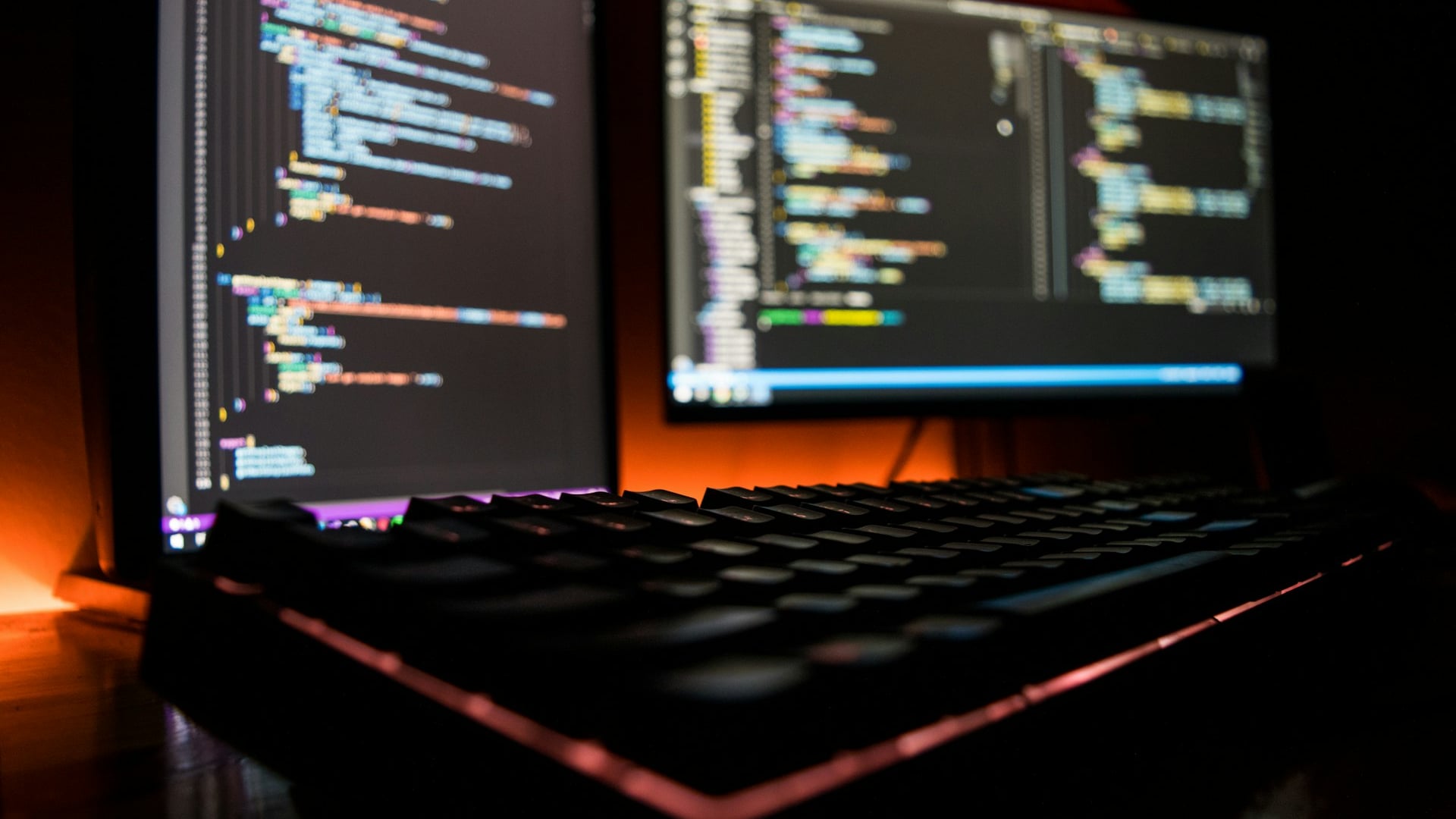 Software engineer writing clean code at a multi-screen developer workstation for ACS skills assessment