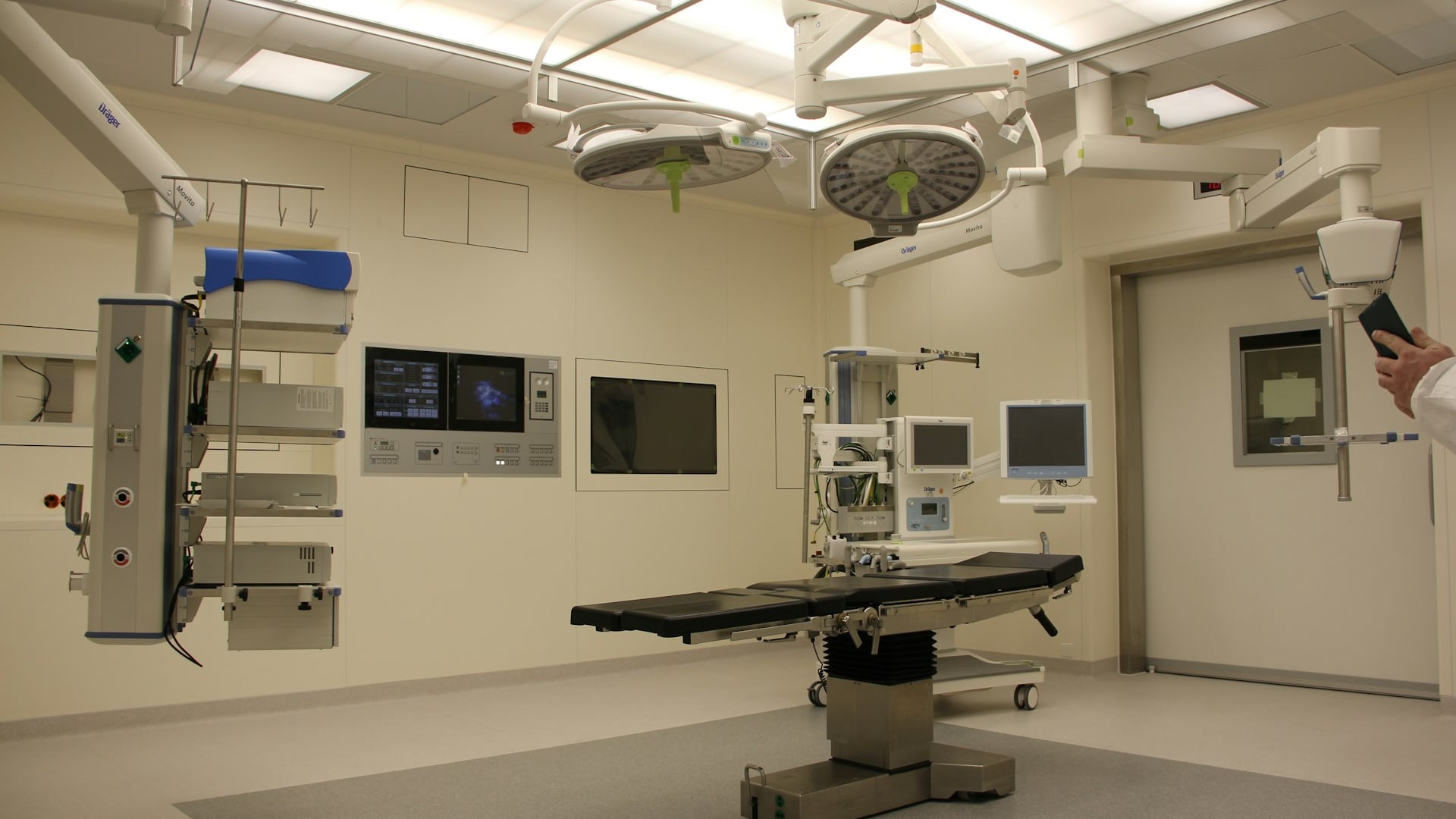 Diagnostic radiographer and imaging specialist evaluating MRI scan results on high-resolution displays for ASMIRT assessment