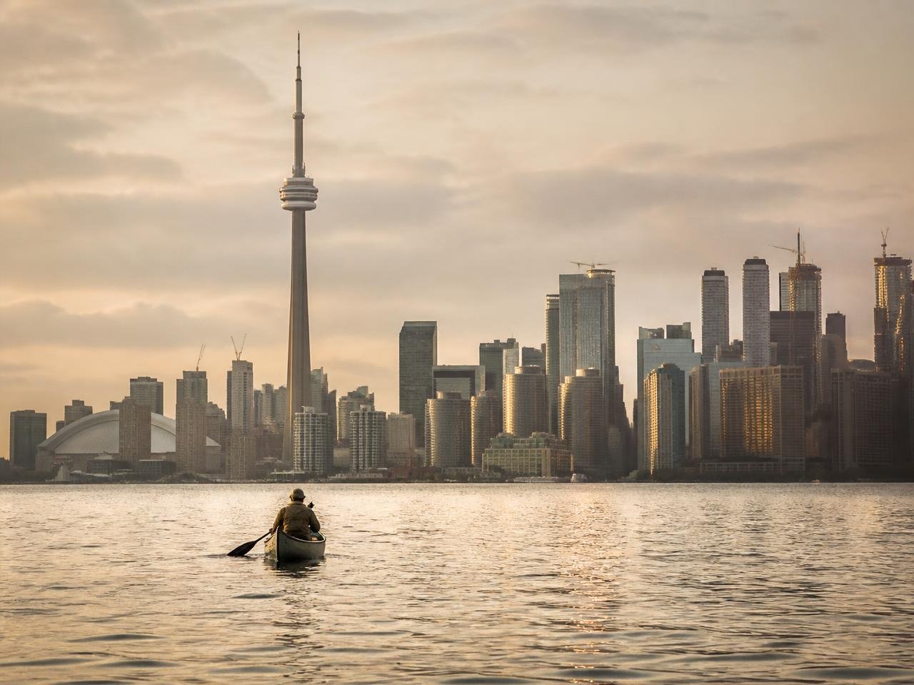 Toronto skyline across the lake at sunset