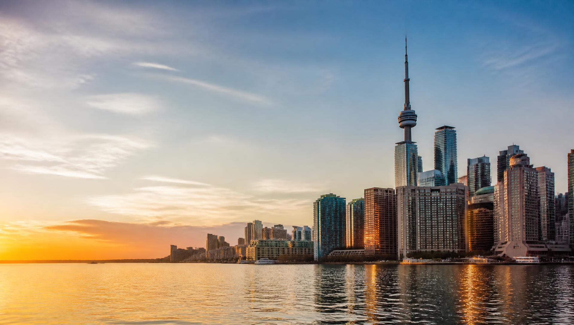 Toronto skyline across the lake at sunset
